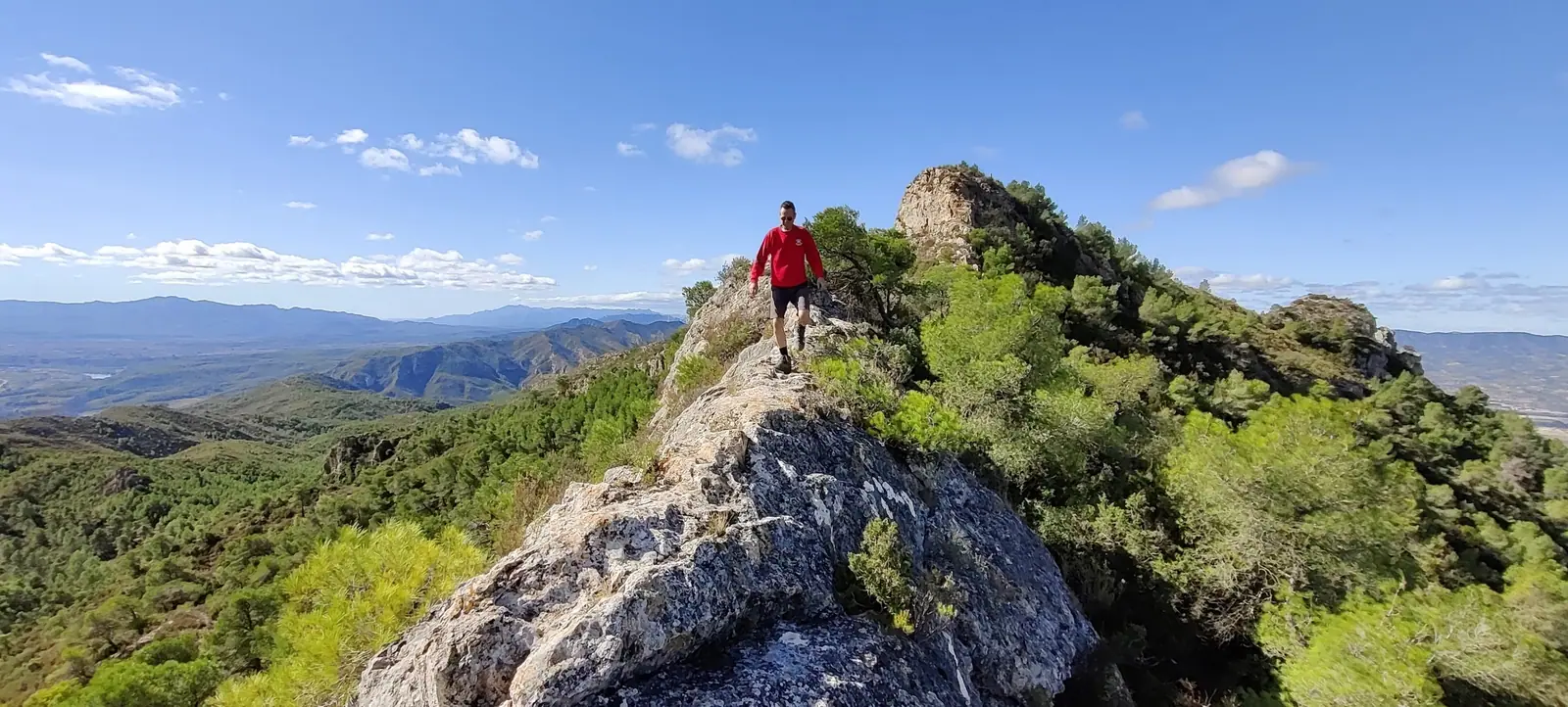 A walker on the rocky ridge above the Ebro valley